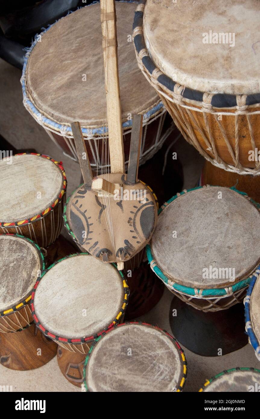 Africa, Gambia. Capital city of Banjul. Typical animal hide covered drums & stringed instrument. Stock Photo
