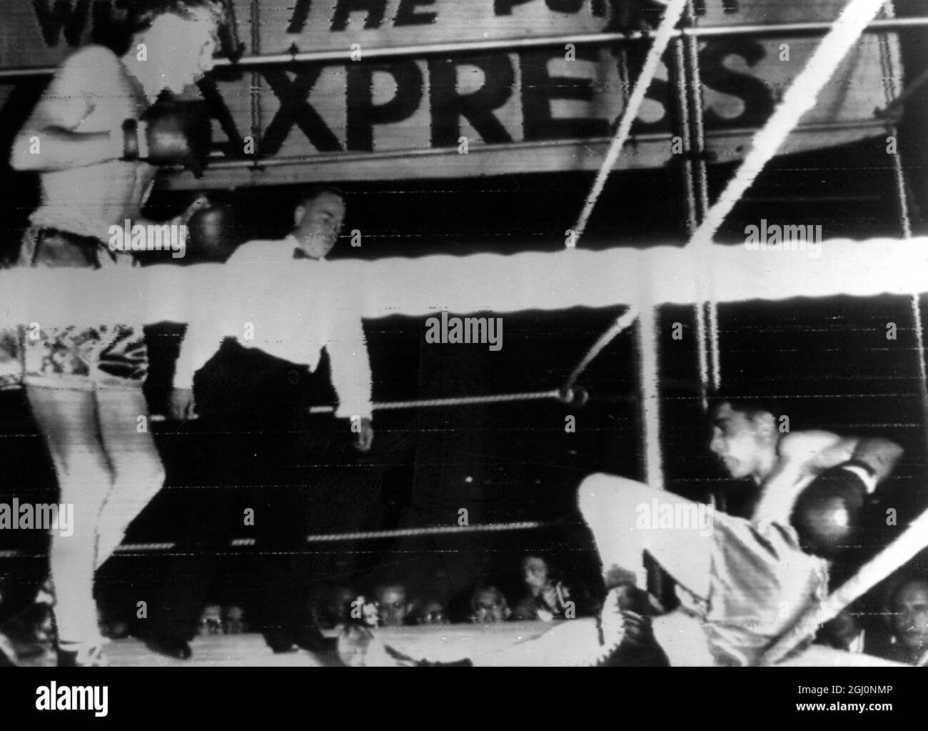 Jimmy Carruthers of Australia knocks Vic Toween of South Africa through the ropes prior to taking Toweel 's world bantam-weight title with a knock-out in the first round of their fight in Johannesburg , South Africa 18th November 1952 Stock Photo