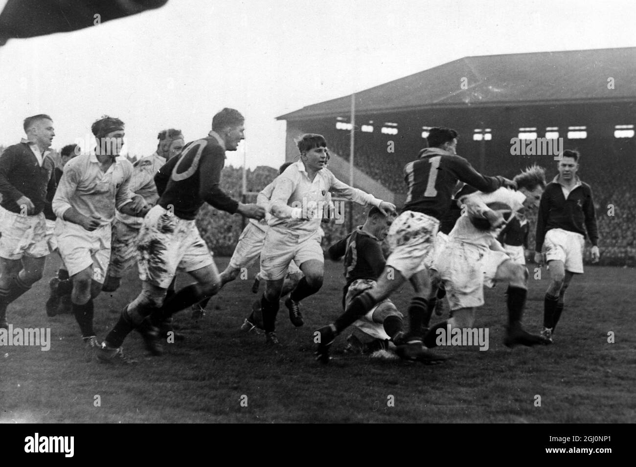 Murrayfield , Scotland : R C Taylor (Kelvinside) , of Scotland , tries a break through and is tackled by South Africa's J D Brewis , followed up by Scotland's J A R MacPhail (Edinburgh) , during the Rugby International , when South Africa beat Scotland 44 - 0 ; the biggest victory ever achieved by a touring side in Britain . Murrayfield , Scotland . 28 September 1951 Stock Photo