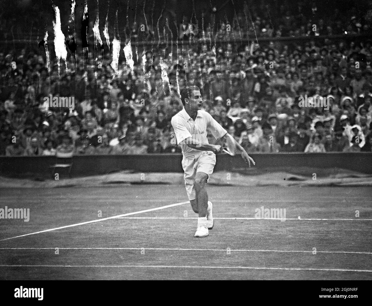 After heavy rain had delayed play for a considerable time H W Austin of Great Britain met A K Quist in the final singles of the Davis Cup Challenge Round between England and Australia at Wimbledon , England . Seen here Bunny Austin in play against Adrian Quist . 28 July 1936 Stock Photo