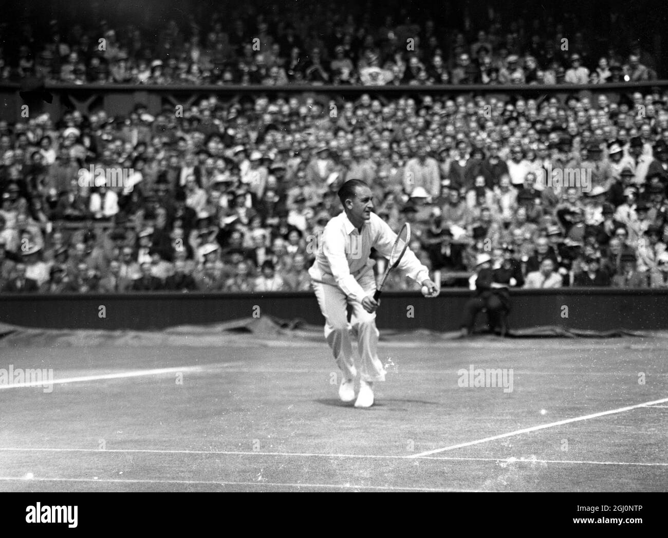 Great Britain , winner of the Cup for three years , met Australia , who have never succeeded in gaining the trophy , in the Challenge Bound of the Davis Cup competition . Bunny Austin of Great Britain met Jack Crawford in the first singles match on the Centre Court . Seen here Crawford in action against Austin 25 July 1936 Stock Photo