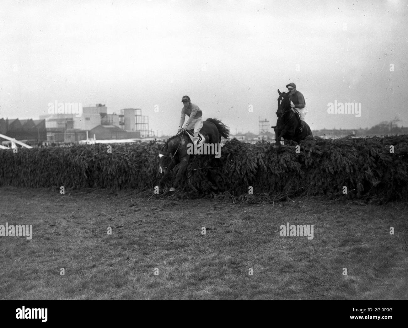 Jay Trump (right) with American amateur jockey , Crompton ( Tommy ) Smith 27 up takes the last fence of the Grand National to go on to win the race . Second was Freddie ridden by Pat McCarron , Aintree , Liverpool , England . 27 March 1965 Stock Photo