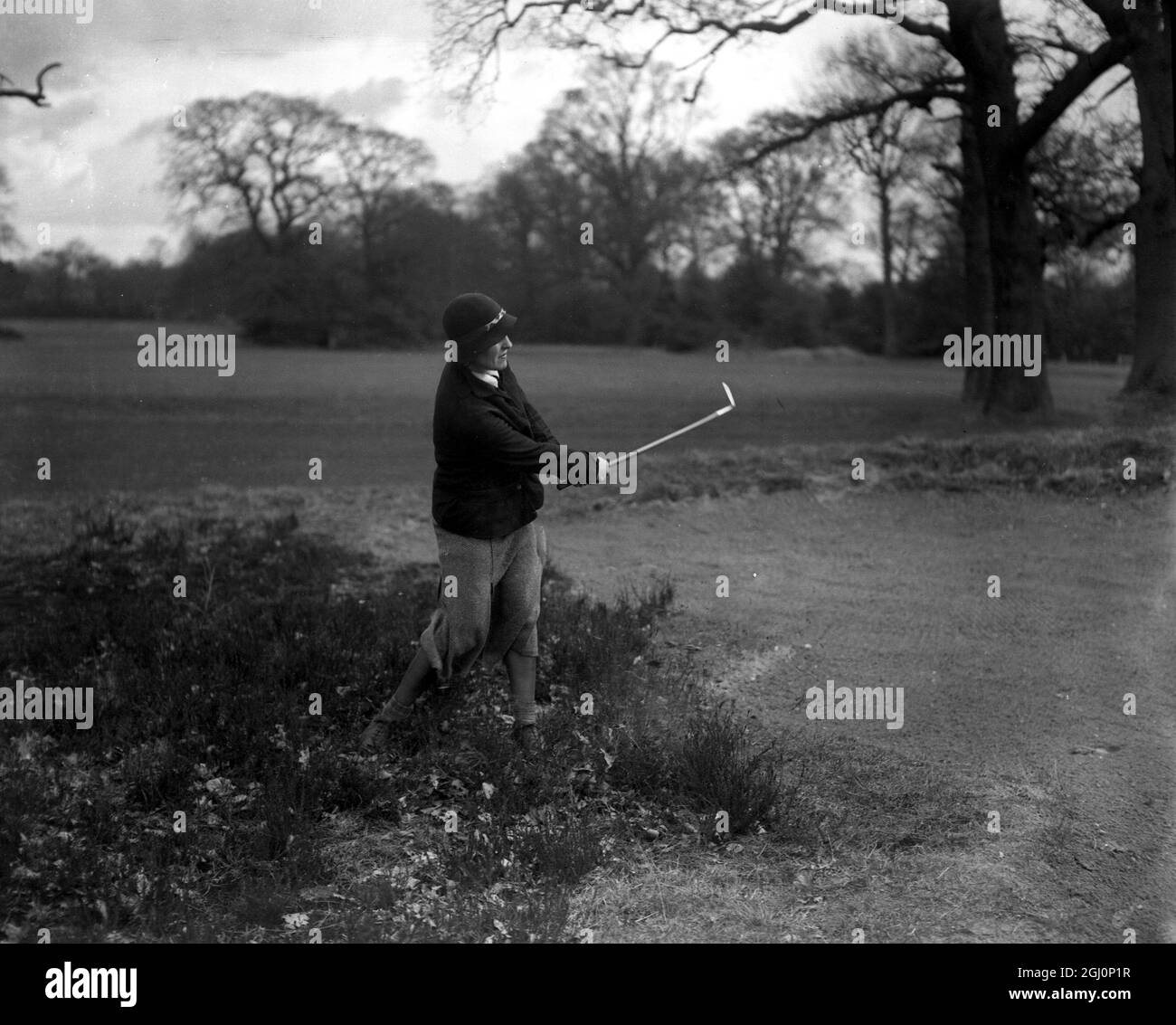 Sportswoman in Golf Championship meeting . Famous sportswomen met on the Burhill course , Surrey , for the Ladies Open meeting at the Women ' s Amateur Sports Association challenge trophy . Photo shows ; Mrs Petch playing from the rough during the match . 31 March 1932 Stock Photo