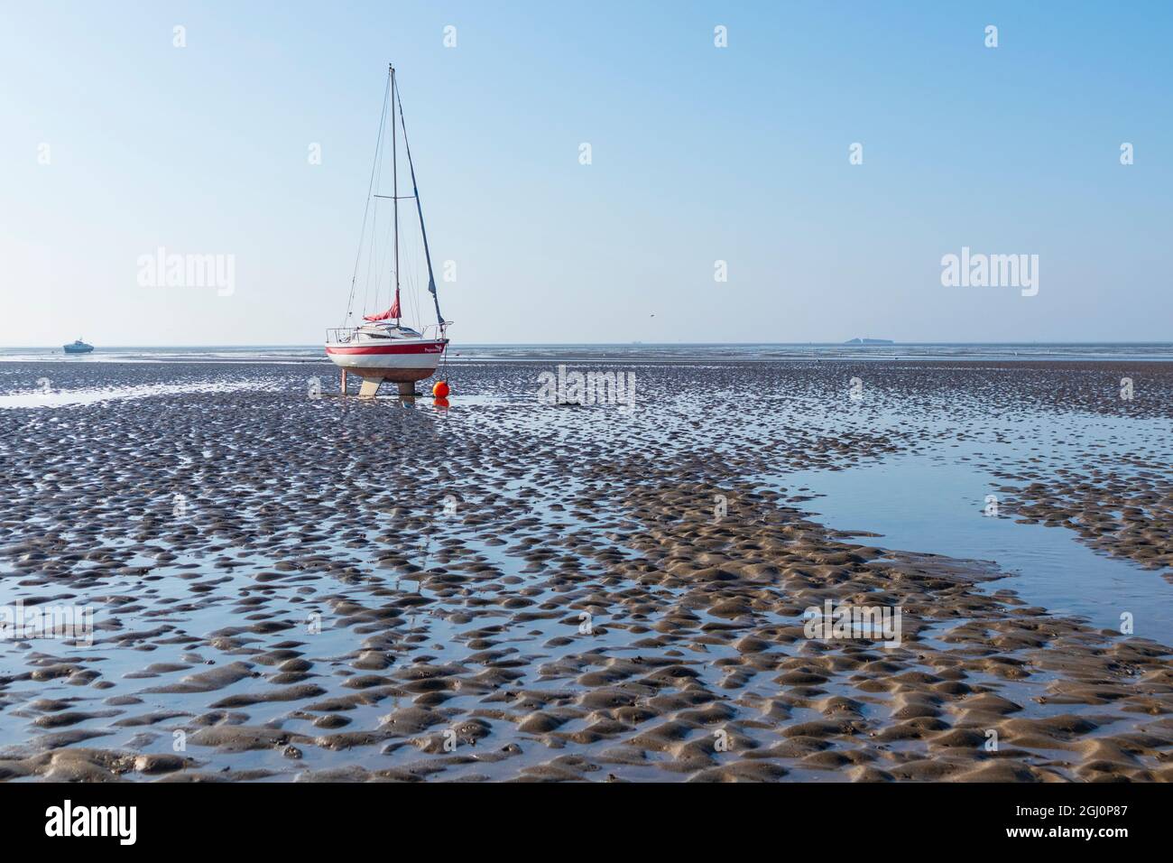 Yacht Named 'Pegasus' High and Dry during Low Tide at Thorpe bay on Thames Estuary on a Lovely Late Summer Morning.Deep Sand Ripples in Foreground Stock Photo