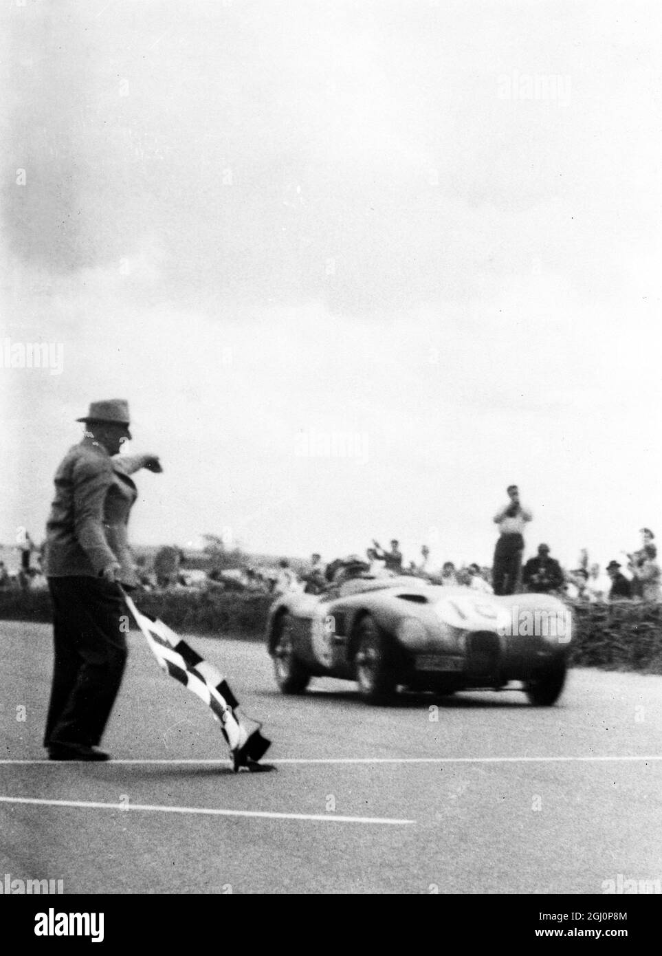Tony Rolt and Duncan Hamilton in their record-breaking Jaguar flagged ...