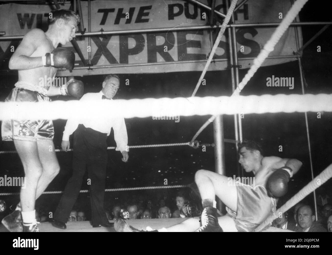 Jimmy Carruthers , of Australia . knocks South Africa's Vib Toweel through the ropes prior to taking Toweel's world bantamweight title with a knock out in the frirst round of their fight here , Johannesburg , South Africa . 18 November 1952 Stock Photo