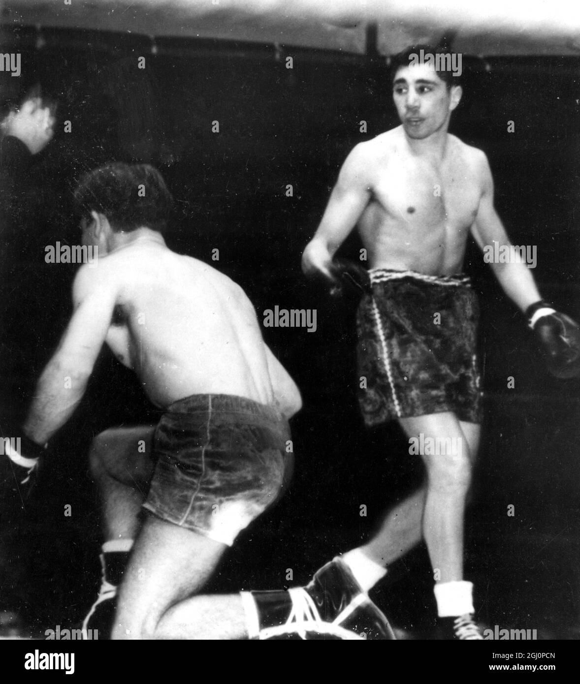 Down on one knee goes Luis Romero , the Spanish champion , who was making a bid to wrest the world bantamweight title from the holder , Vic Toweel (right) , Johannesburg , South Africa . The championship was retained by Toweel , who won the 15 round contest with a decisive points win . 20 November 1950 Stock Photo