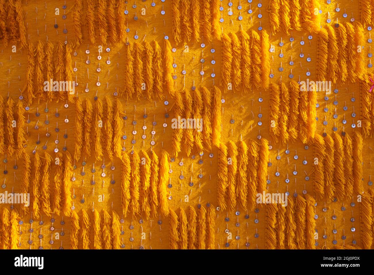 Close-up of vertical rug, hanged to the wall, used as decoration. Stock Photo
