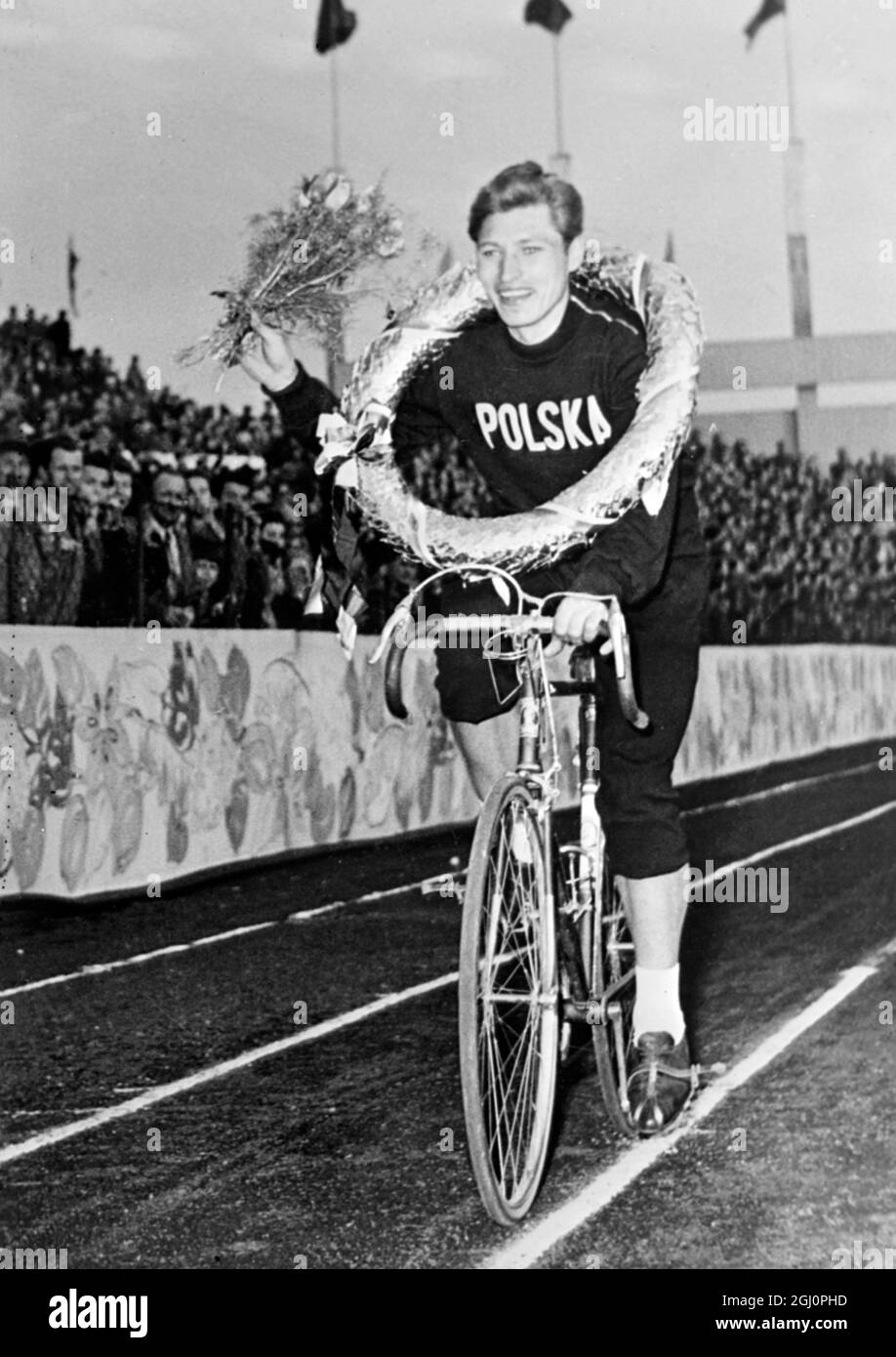 Warsaw , Poland : Waving a bouquet and wearing a laurel garland Poland's Krolak makes a lap of honour after being declared overall winner of the 9th Warsaw - Berlin - Prague Peace race . The final stage of the tour was from Brno to Prague , a distance of 224 kilometres . Russia were the team winners and Klevtsov of the USSR the winner of the final stage . 18 May 1956 Stock Photo