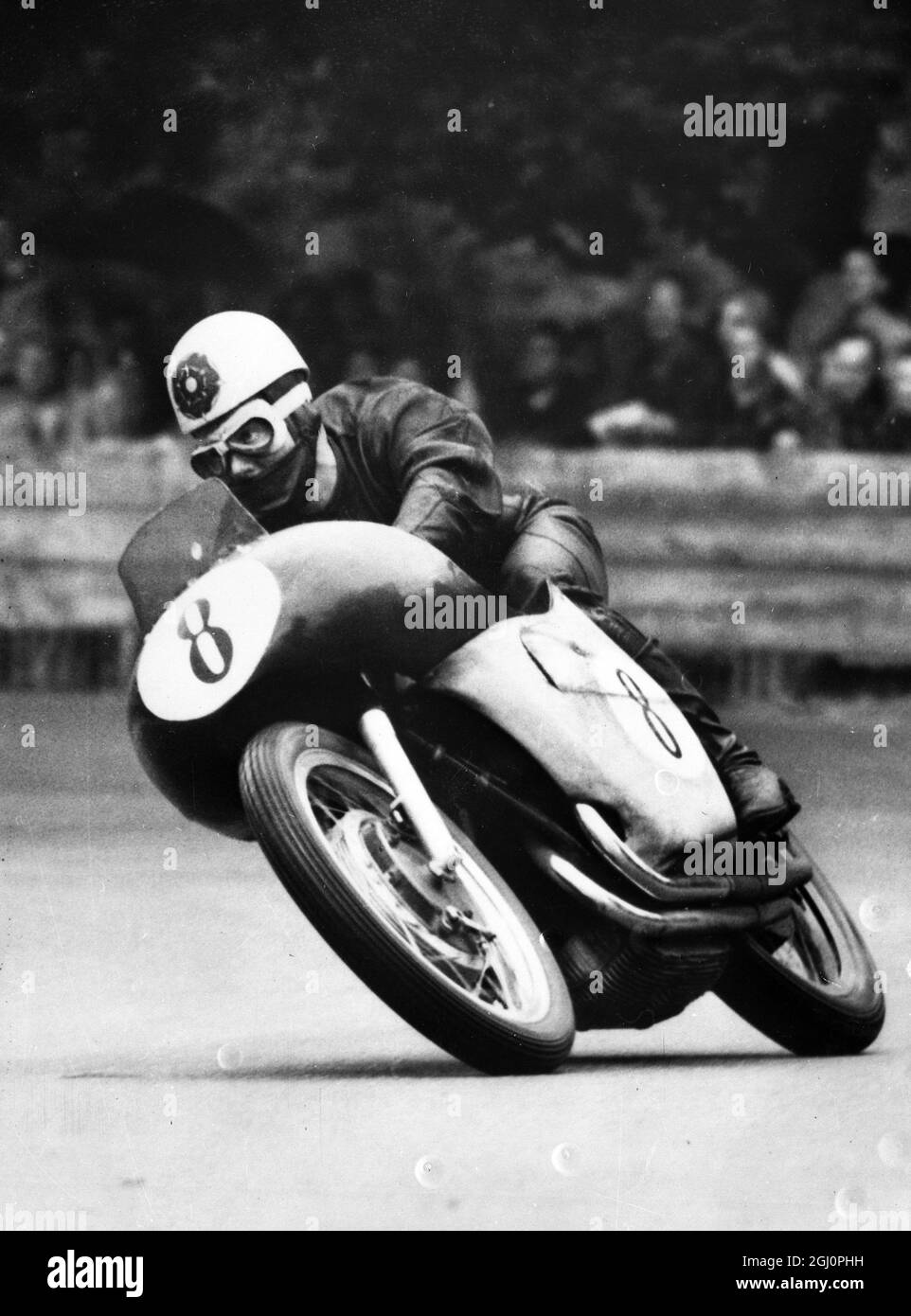 Riding a Gilera , Geoff Duke wins the 500 cc event in the Grand Prix of Berne . He averaged 93.73 miles per hour to beat Ray Amm of Australia by 3.7 seconds . Duke now leads the world championship field by 4 points . 23 August 1954 Stock Photo