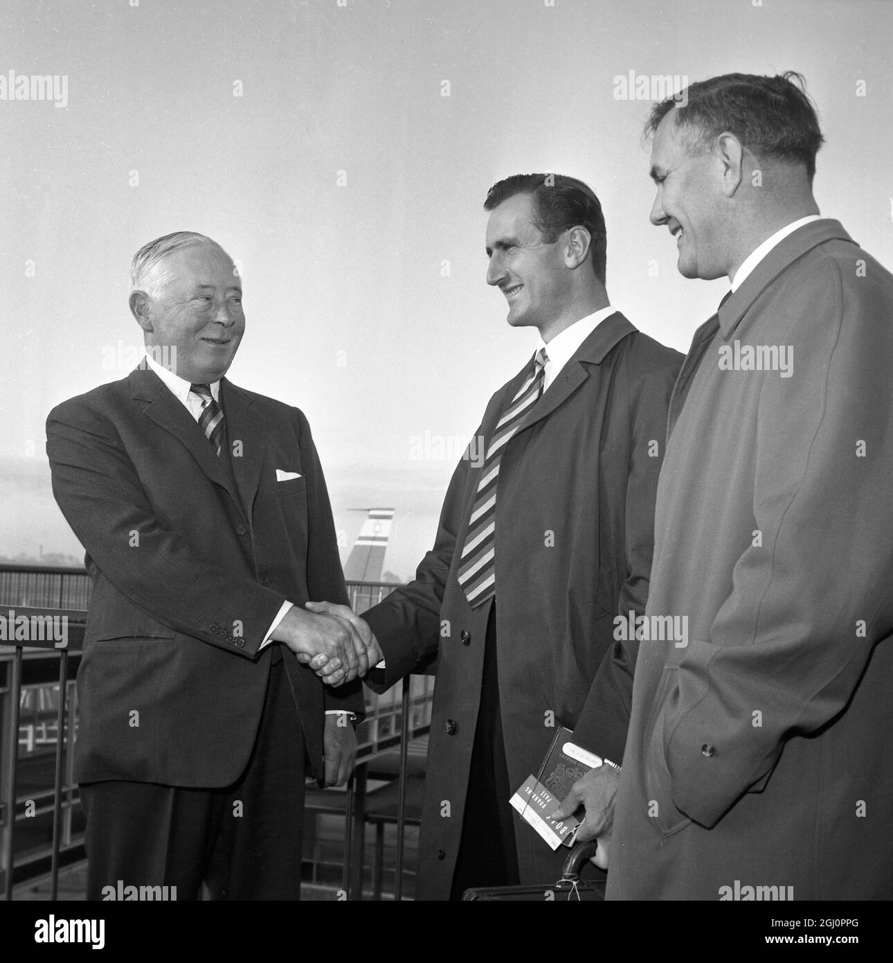 As Assistant Manager Alec Bedser looks on , the Duke of Norfolk , Manager of the MCC team which left London Airport for a five-months cricket tour of Australia and New Zealand , bids farewell to the team's captain , Ted Dexter , before the team left the airport this morning for Aden . 27 September 1962 Stock Photo