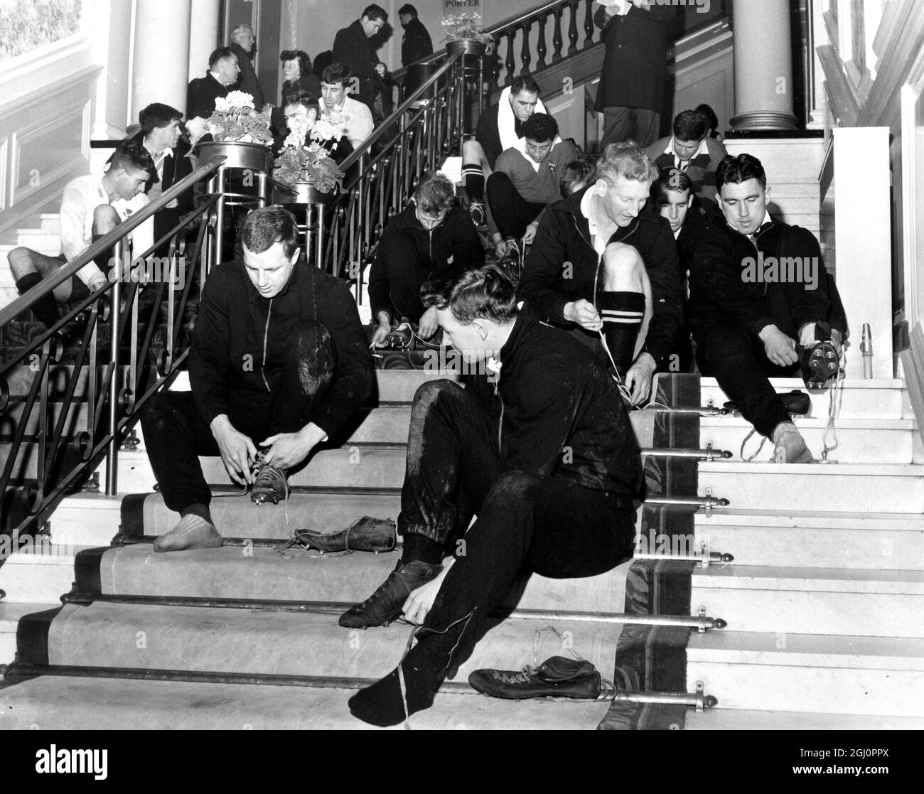 The All Blacks Rugby team take over the stairs in the foyer of their Peebles Hotel , Scottish Borders , before going out for a training session shortly afer their arrival from Aberdeen . 17 January 1964 Stock Photo