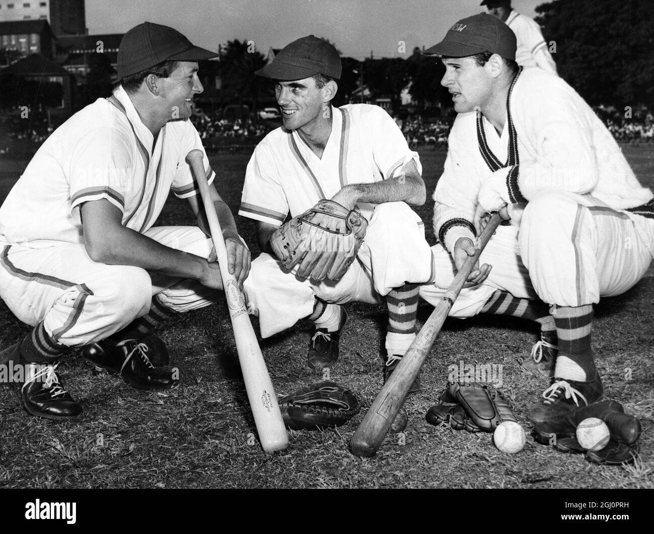 Cricket heroes and now baseball too. Australian Richie Benaud (left) , Ian Craig and Norm O'Neill are quite at home on the baseball pitch . Here, they plan their attack before beating the New South Wales baseball team . The cricketers won by 5 to 1 . Only a few weeks ago , Benaud led Australia to victory over England in a series of five test matches . O'Neill was invited to join the New York Yankees in Spring training but decided against it . 27 April 1959 Stock Photo