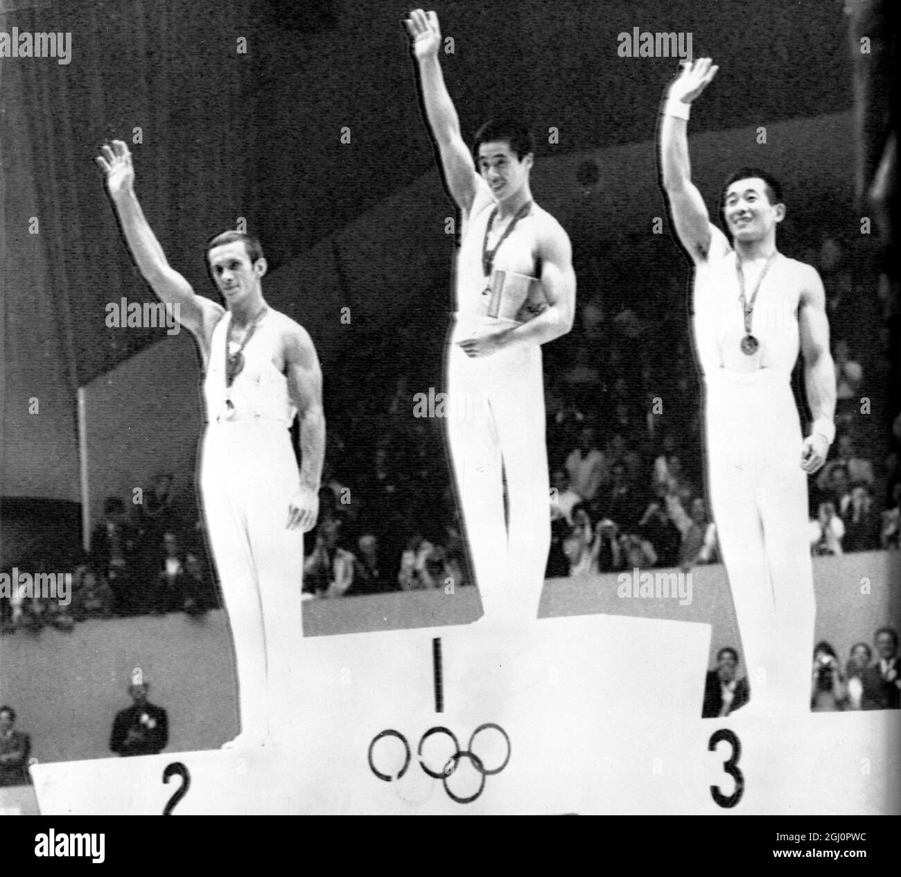 Mexico City : Medal winners of the Men's Combined Gymnastics on the victory podium in Mexico City . From left: Mikhail Voronin ( USSR ), silver ; Sawao Kato ( Japan ), Gold and Akinori Nakayama , also Japan , Bronze 25 October 1968 Stock Photo
