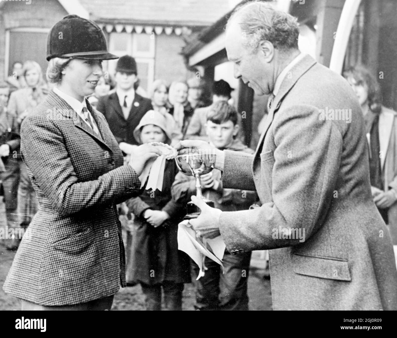 Another prize for Princess Anne . Tweedlesdown , hampshire : Princess Anne , daughter of Britain's Queen Elizabeth II , is pictured here receiving an award and a rosette from Brigadier DT bastin for her performance at the Staff College and Sandhurst Pony Club Horse Trials , on her pony '' High Jinks '' . The Princess won the award for the under-17 competitors in the individual . She had brilliant marks in the dressage , no faults in the cross-country and no faults in the show jumping. She was riding for the Garth Junior Pony Club . 23 April 1966 Stock Photo