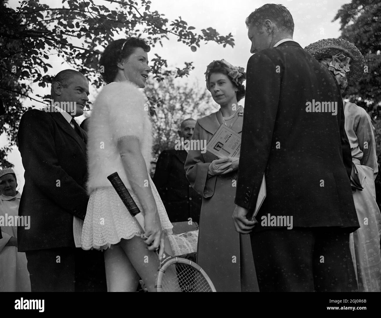 HRH Princess Elizabeth attended the Annual Lawn Tennis Exhibition matches held by Lady Crosfield in aid of the National Children's Palyground Association at 41 Highgate West Hill , London , N6 . Seen here at the party LtoR Barbara Scofield Davidson , the US player , Princess Elizabeth and Mr Davidson , Barbara Scofield 's husband 20 June 1951 Stock Photo