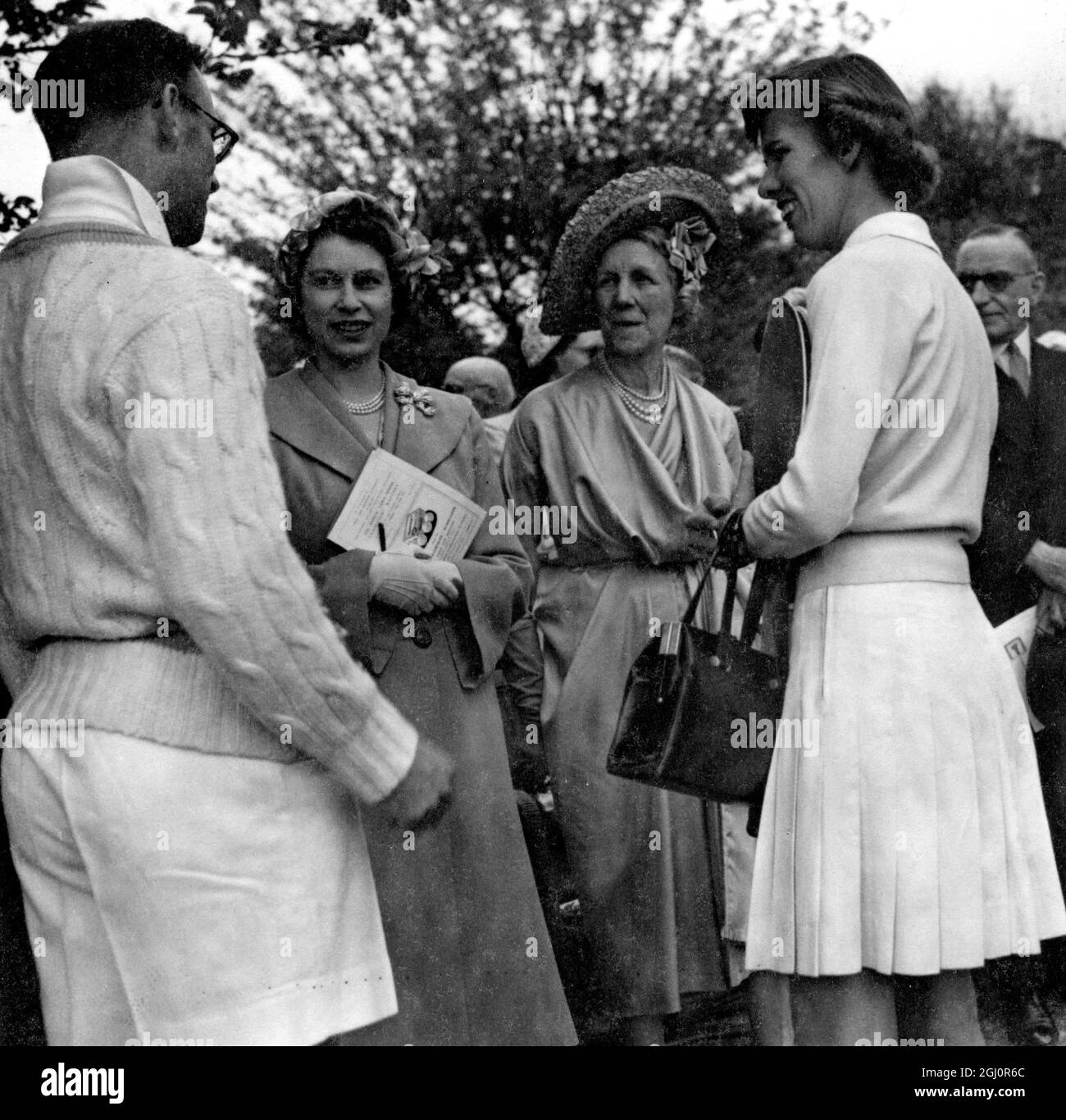 HRH Princess Elizabeth attended the Annual Lawn Tennis Exhibition matches held by Lady Crosfield in aid of the National Children's Palyground Association at 41 Highgate West Hill , London , N6 . Seen here at the matches LtoR Geoffrey Paish ( British player ), Lady Crosfield , Princess Elizabeth and Doris Hart ( US player ). 20 June 1951 Stock Photo