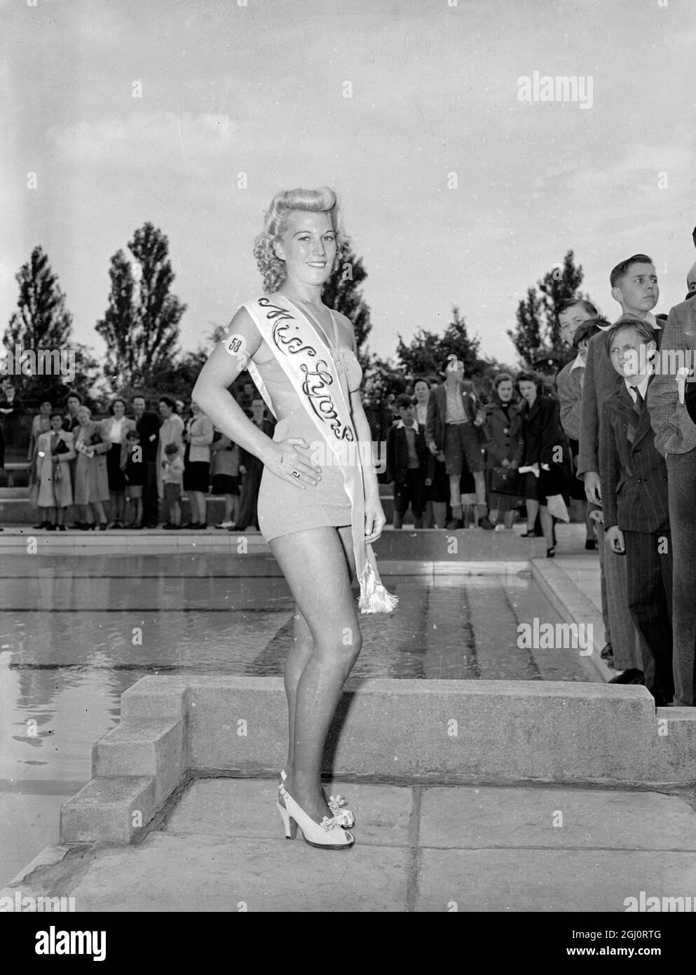 PATRICIA ROC AND TEN BEAUTY QUEENS ATTENDED LYONS CLUB ANNUAL SPORTS Ten Beauty Queens from London Boroughs attended the Lyons Club annual sports and carnival at Sudbury to-day. They served as models for Patricia Roc and Trevor Howard, who have to decide which ''Nippy'' shall be ''Miss Lyons'' of 1947. The new Lyons Queen will make a ''state drive'' round the sports arena this evening. Ten hours of carnival are provided in addition to boxing, diving and swimming displays. The evening closes with a fireworks display. Photo Shows: ''Miss Lyons 1947'' - Miss Lilly Layton of Wembley, who is a swim Stock Photo