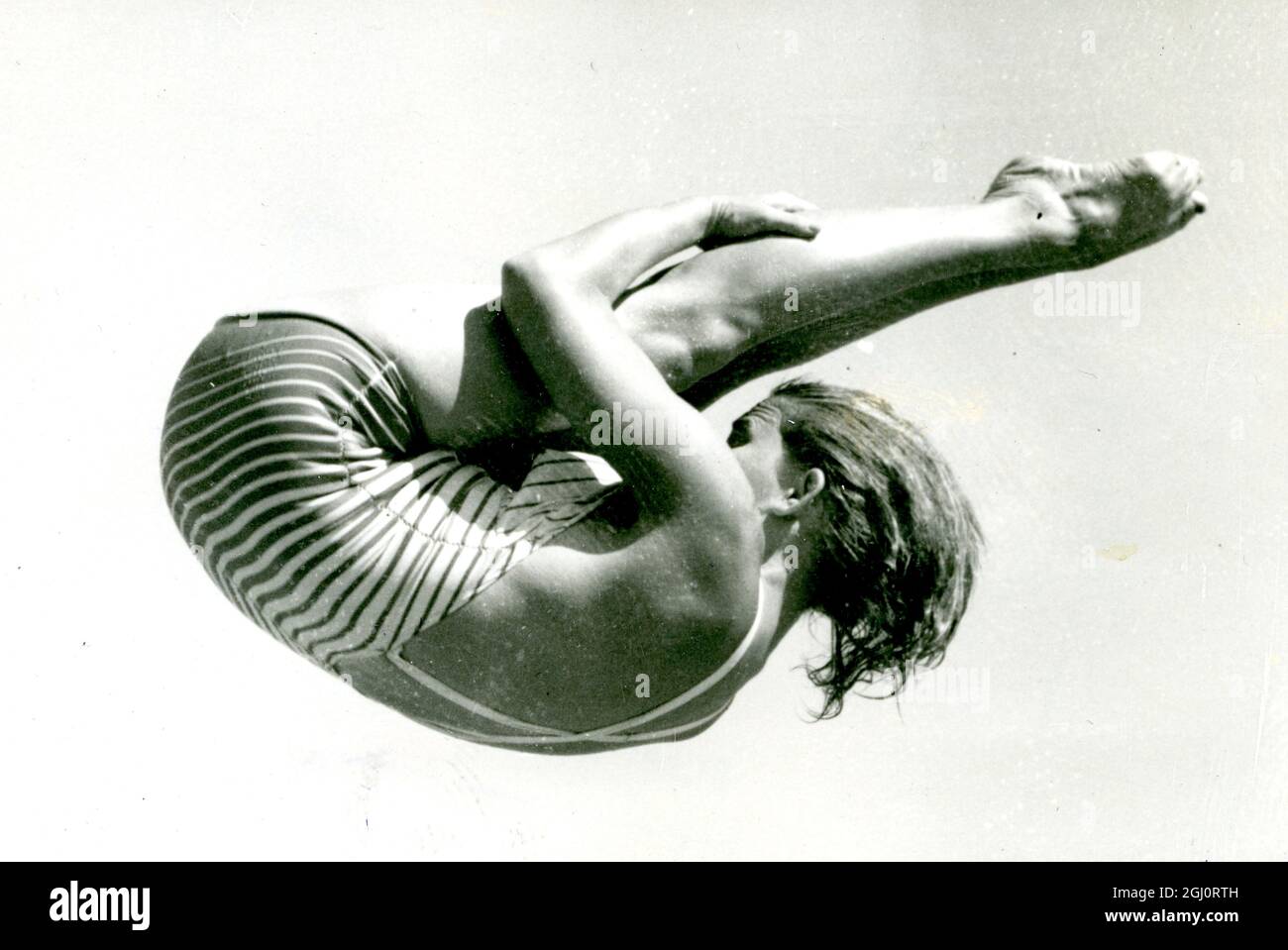American diver Patricia McCormick curl herself tightly and gracefully in mid-air during practice for the Olympic diving at the Olympic pool here , Helsinki , Finland . 29 July 1952 Stock Photo