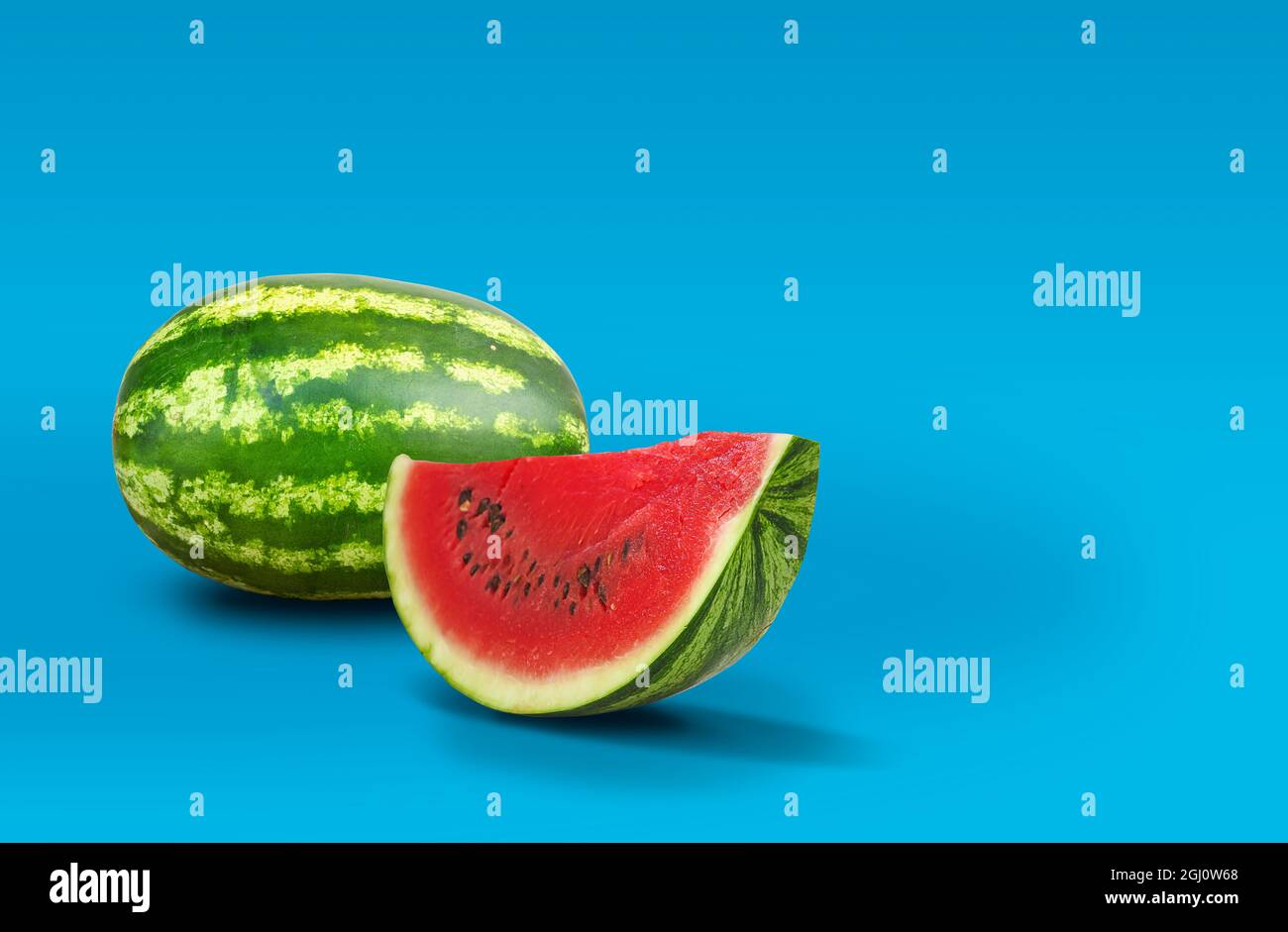Ripe watermelon and slice isolated on blue background with copy space Stock Photo