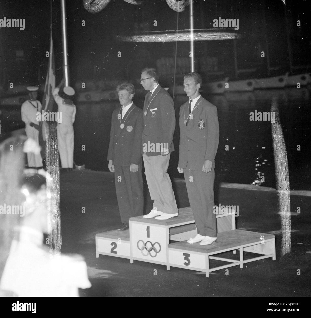 Picture shows winners of the Olympic Yachting, Finn class, on the podium during the medal presentation last night. In the centre is the Gold Medallist Denmark Paul Bert Elvstrom. At the left the Silver medallist Alexandr Chuchelov (USSR), and at the right the Bronze Medallist of Belgium Andre Nelis. The medals were presented by Iva Vind the Danish Member of the International Olympic Committee. 8 SEPTEMBER 1960 Stock Photo