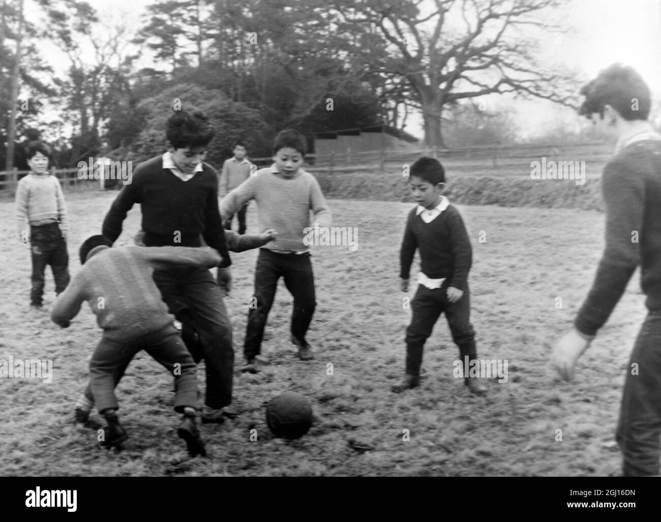 REFUGEES TIBETAN BOY PLAYS FOOTBALL IN SUSSEX ; 1 APRIL 1963 Stock Photo