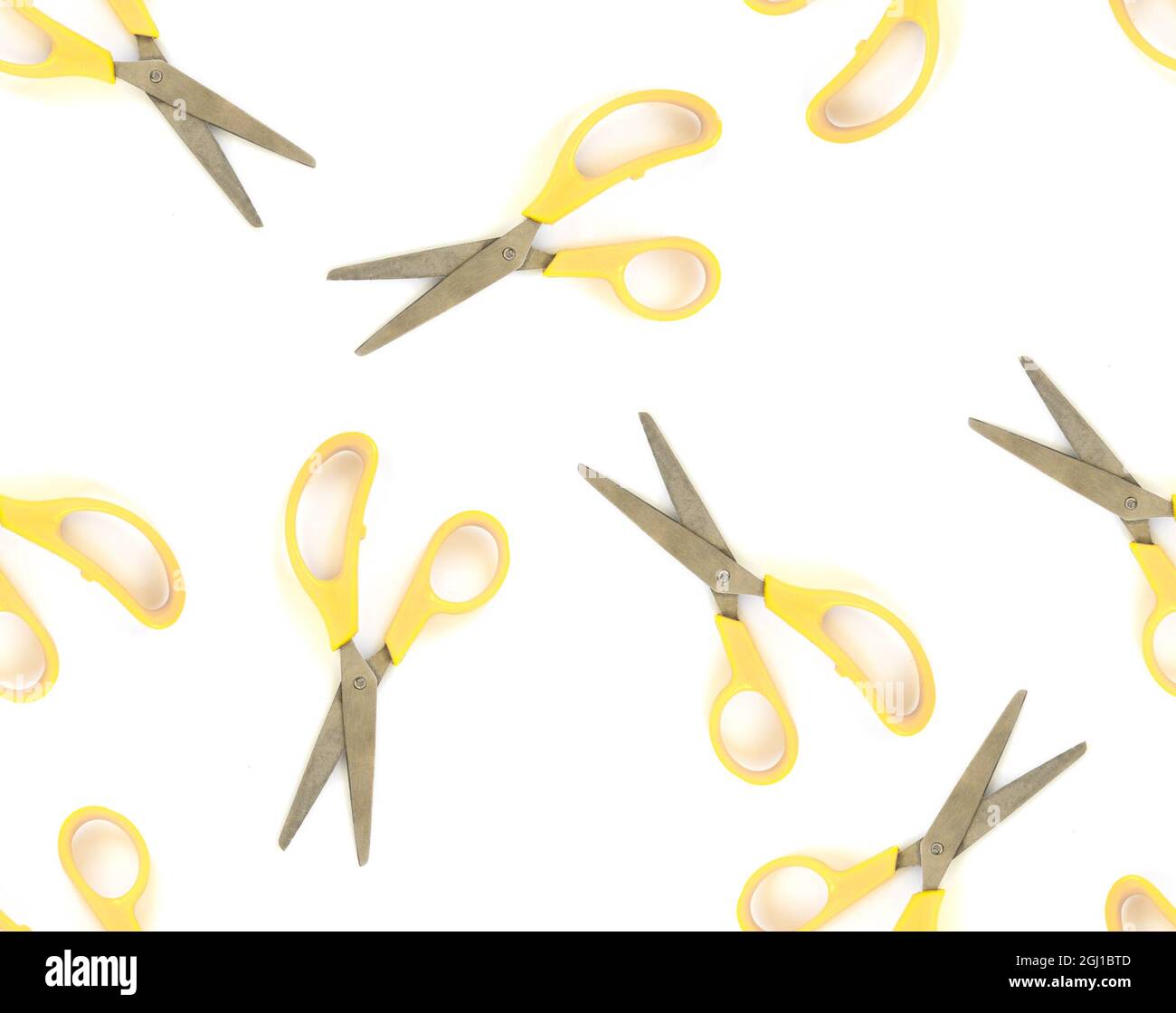 Seamless pattern yellow scissors on white isolated background Stock Photo