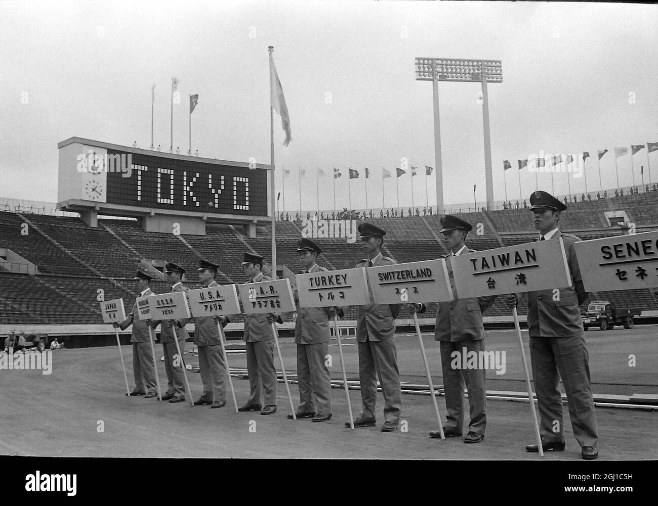 OLYMPICS OPENING REHERSAL STANDARD BEARERS SHOW NAMES NATIONS  AT OLYMPICS IN TOKYO, JAPAN, SUMMER OLYMPIC GAMES ;  29 SEPTEMBER 1964 Stock Photo