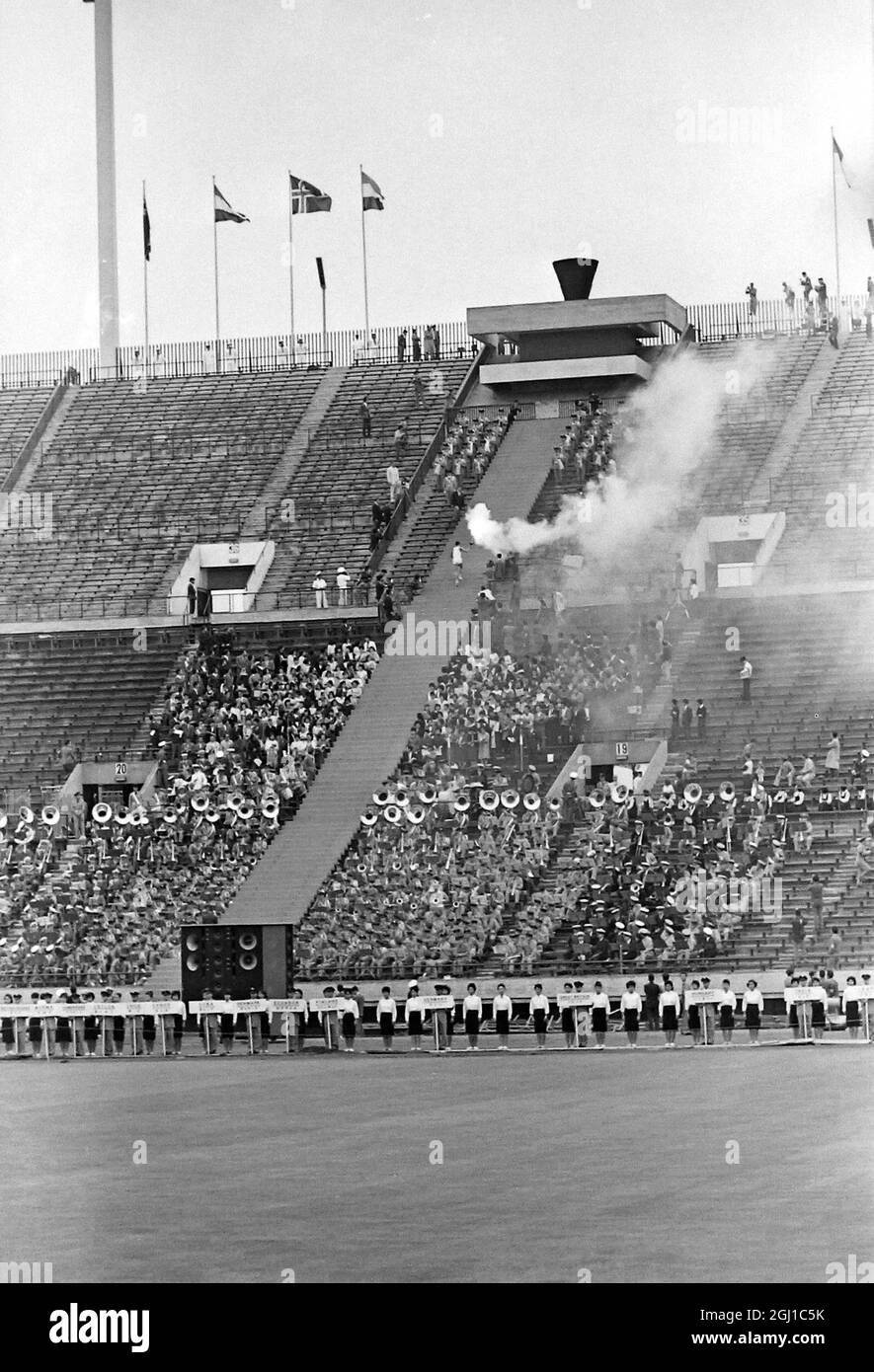 OLYMPICS NATIONAL STADIUM ATHLETE BEARS BURNING TORCH UP STEPS  AT OLYMPICS IN TOKYO, JAPAN, SUMMER OLYMPIC GAMES ;  29 SEPTEMBER 1964 Stock Photo