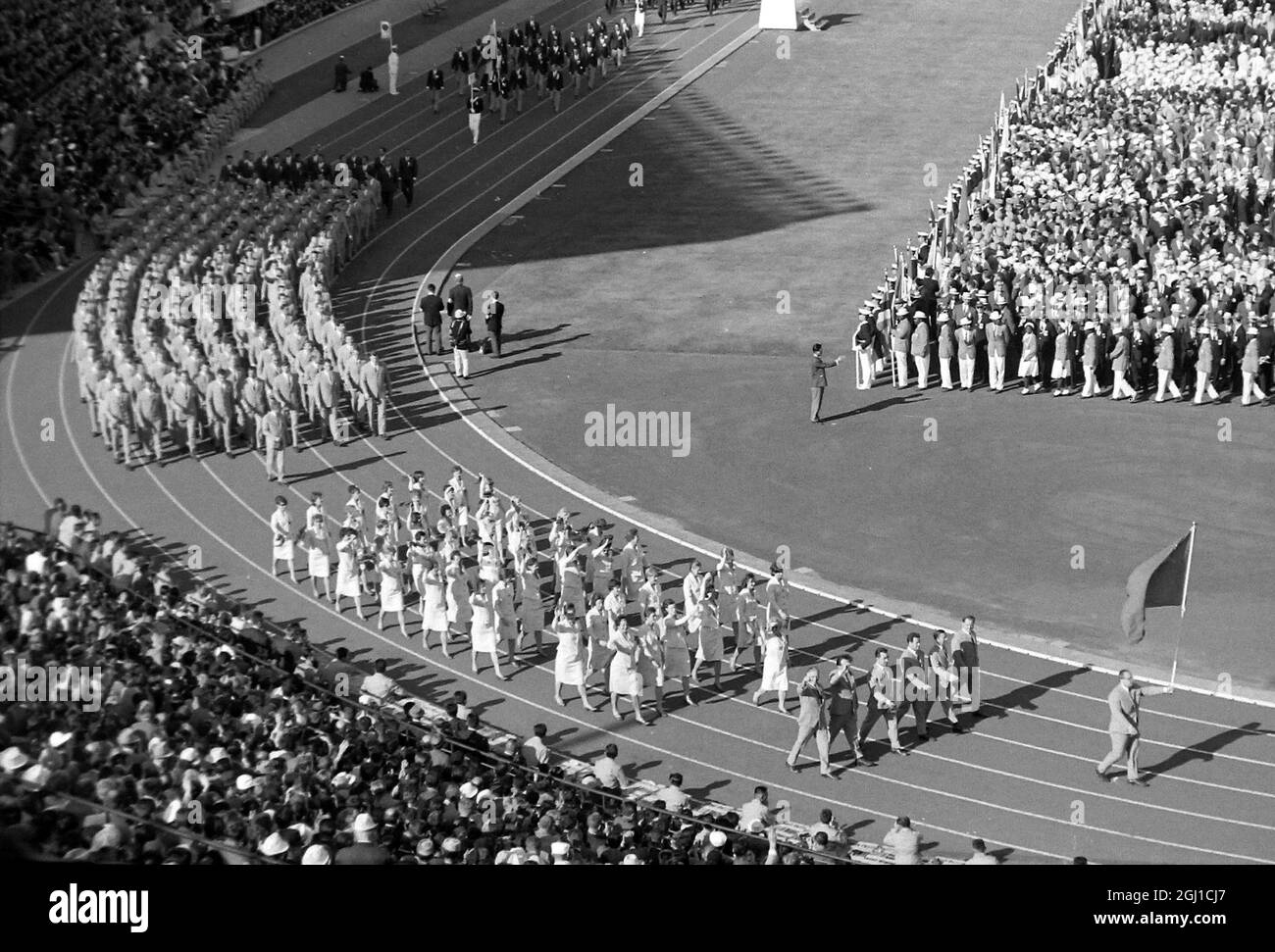OLYMPICS, OLYMPIC SPORT GAMES - THE XVIII 18TH OLYMPIAD IN TOKYO, JAPAN - OPENING CEREMONIES WEIGHTLIFTER VLASOV HOLDS SOVIET FLAG  ;  11 OCTOBER 1964 Stock Photo