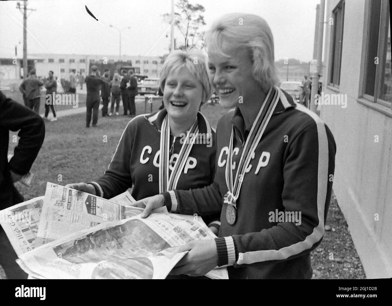 OLYMPICS, OLYMPIC SPORT GAMES - THE XVIII 18TH OLYMPIAD IN TOKYO, JAPAN - SWIMMING 2 RUSSIAN SWIMMERS READ NEWSPAPERS OLYMPIC VILLAGE  ;  14 OCTOBER 1964 Stock Photo