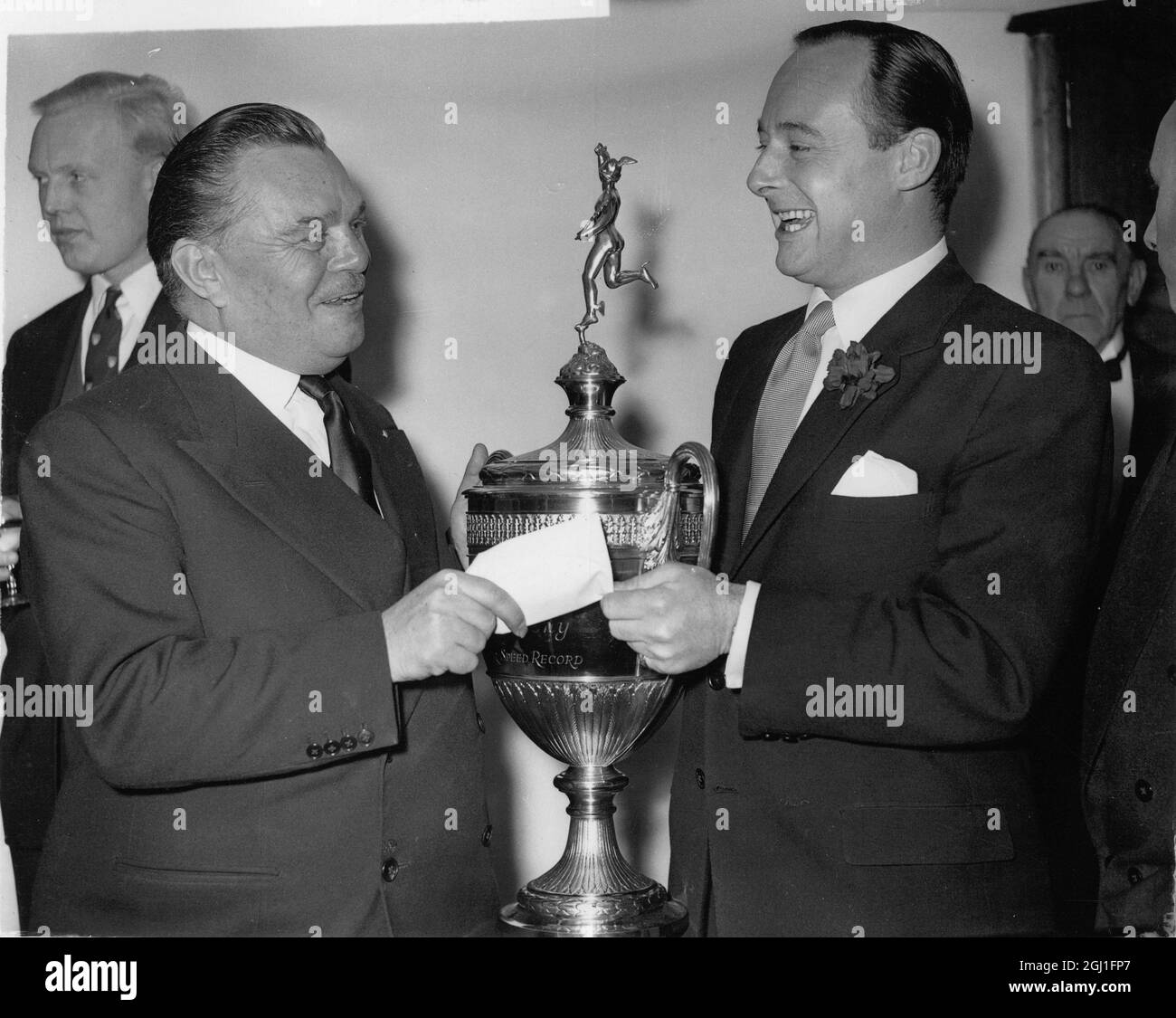 Billy Butlin presents a gold cup and a cheque for £5000 to Donald Campbell for raising his own world water speed record . Variety Club's annual Sport celebrities luncheon at Savoy Hotel , London . 13 January 1959 Stock Photo
