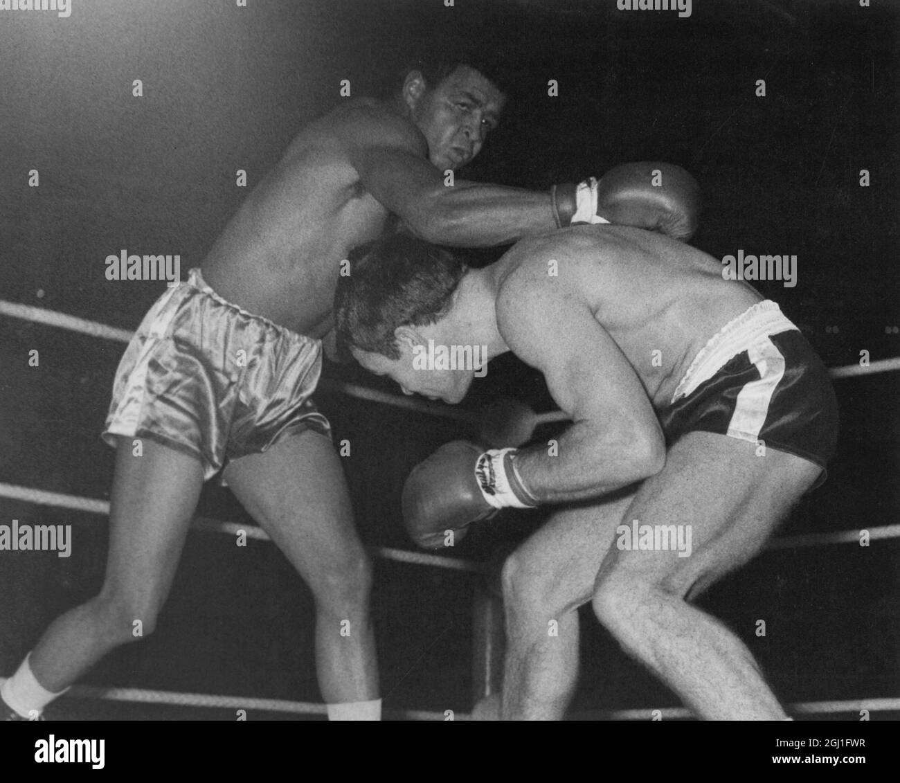 Boxing . Dave Charnley , the British and European lightweight champion beat coloured American J D Ellis when the fight was stopped in the 6th round , at the Royal Albert Hall , London . Charnley ducks away from a right by Ellis . 12th December 1962 Stock Photo