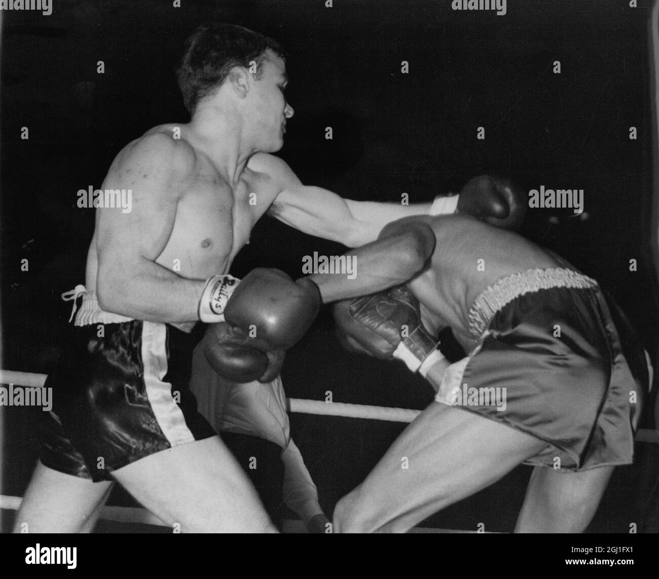 Don Jordan of California ducks beneath a left from British lightweight champion Dave Charnley during their 10 round contest at Harringay , London . Charnley won on points . 28th January . 1958 Stock Photo