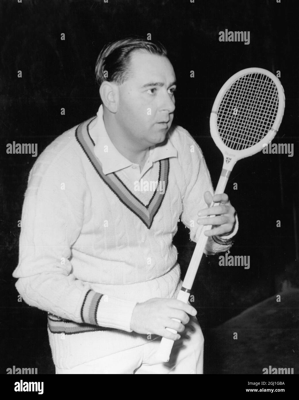 Colin Cowdrey swaps his bat for a racket playing in Tonbridge Kent 1963 Stock Photo