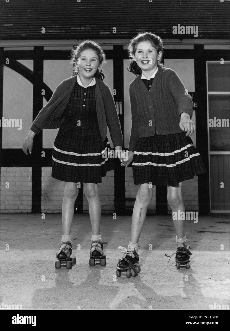 Ponytail twins Susan and Sandra Owen can only be told apart by the mole behind Sandra's ear, hence the reason behind their hairstyle . Both identical twins are seen roller skating in identical outfits . 19 May 1965 Stock Photo