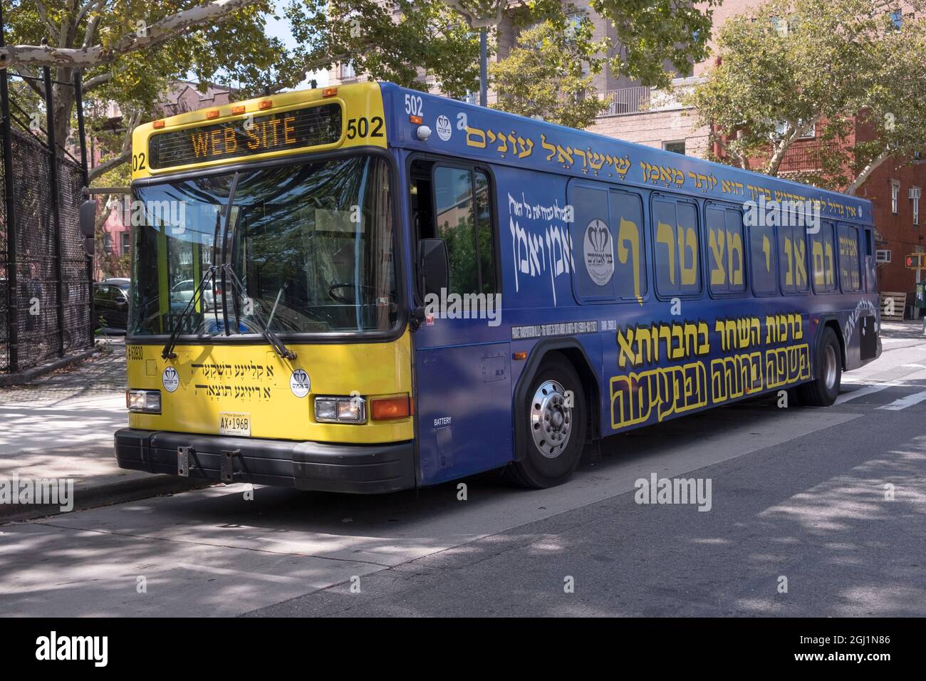 A Bnei Emunim private company bus transporting orthodox Jews from Williamsburg to Borough Park On Lee Avenue in Brooklyn, New York. Stock Photo