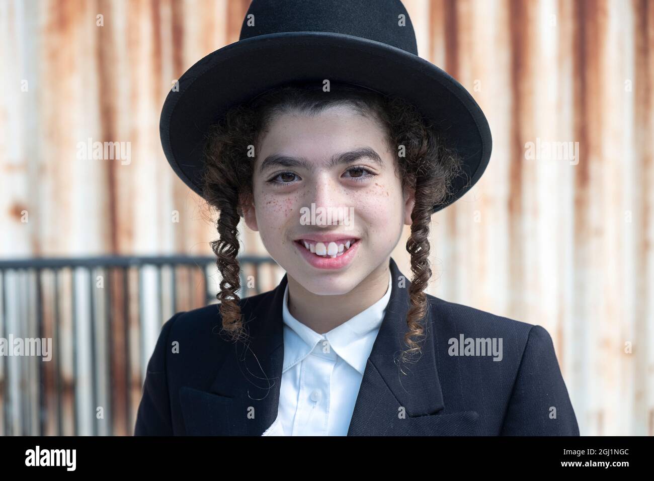 Portrait of a teenage Hasidic Jewish boy with freckles. On Lee Avenue in Williamsburg, Brooklyn, New York. Stock Photo