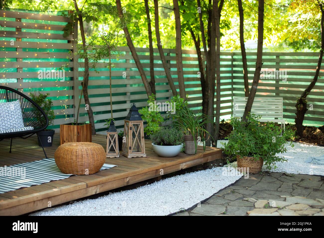 Cozy garden corner. Interior Terrace with plants and wooden porch of ...
