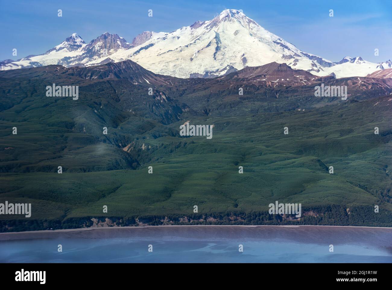 USA, Alaska, Lake Clark National Park. Aerial of Mt. Iliamna and Cook Inlet Stock Photo