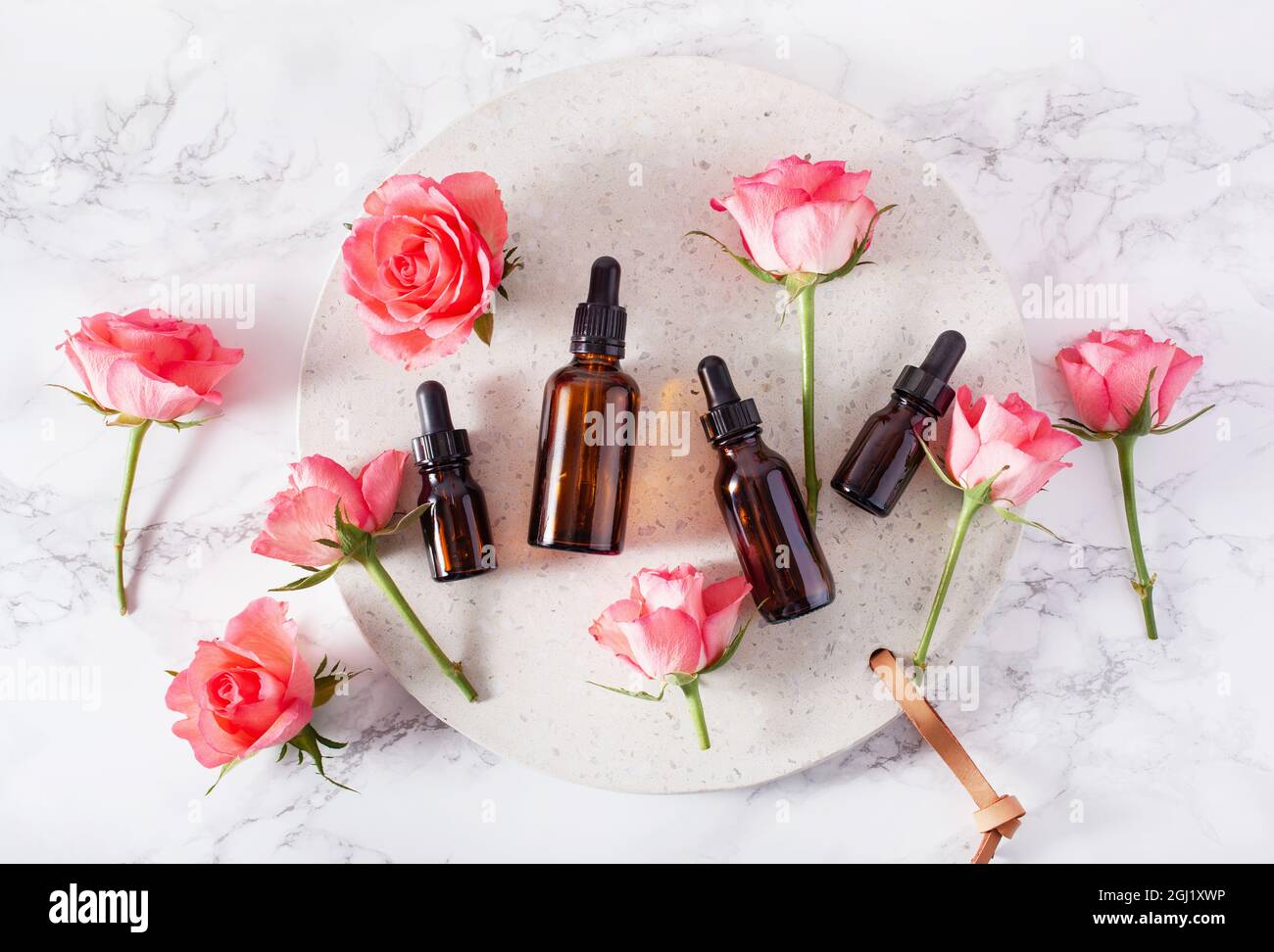 essential oils in bottles rose flowers. alternative medicine spa aromatherapy Stock Photo