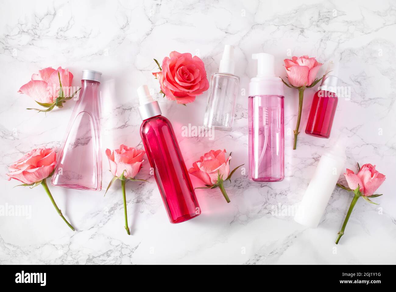 bottles skincare lotion serum medical rose flowers. organic natural cosmetic Stock Photo