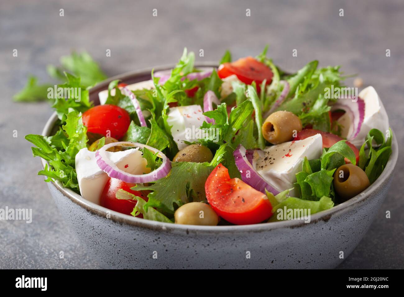tomato salad with brie cheese olives onion lettuce Stock Photo Alamy
