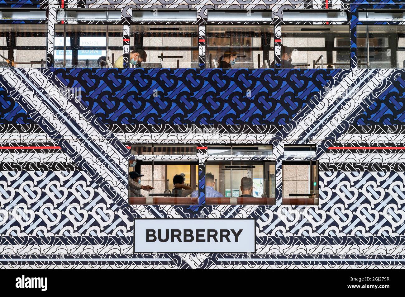 Hong Kong, China. 3rd Aug, 2021. Commuters ride on a double-deck tram  covered with the British luxury fashion company Burberry brand  advertisement theme in Hong Kong. (Credit Image: © Budrul Chukrut/SOPA  Images