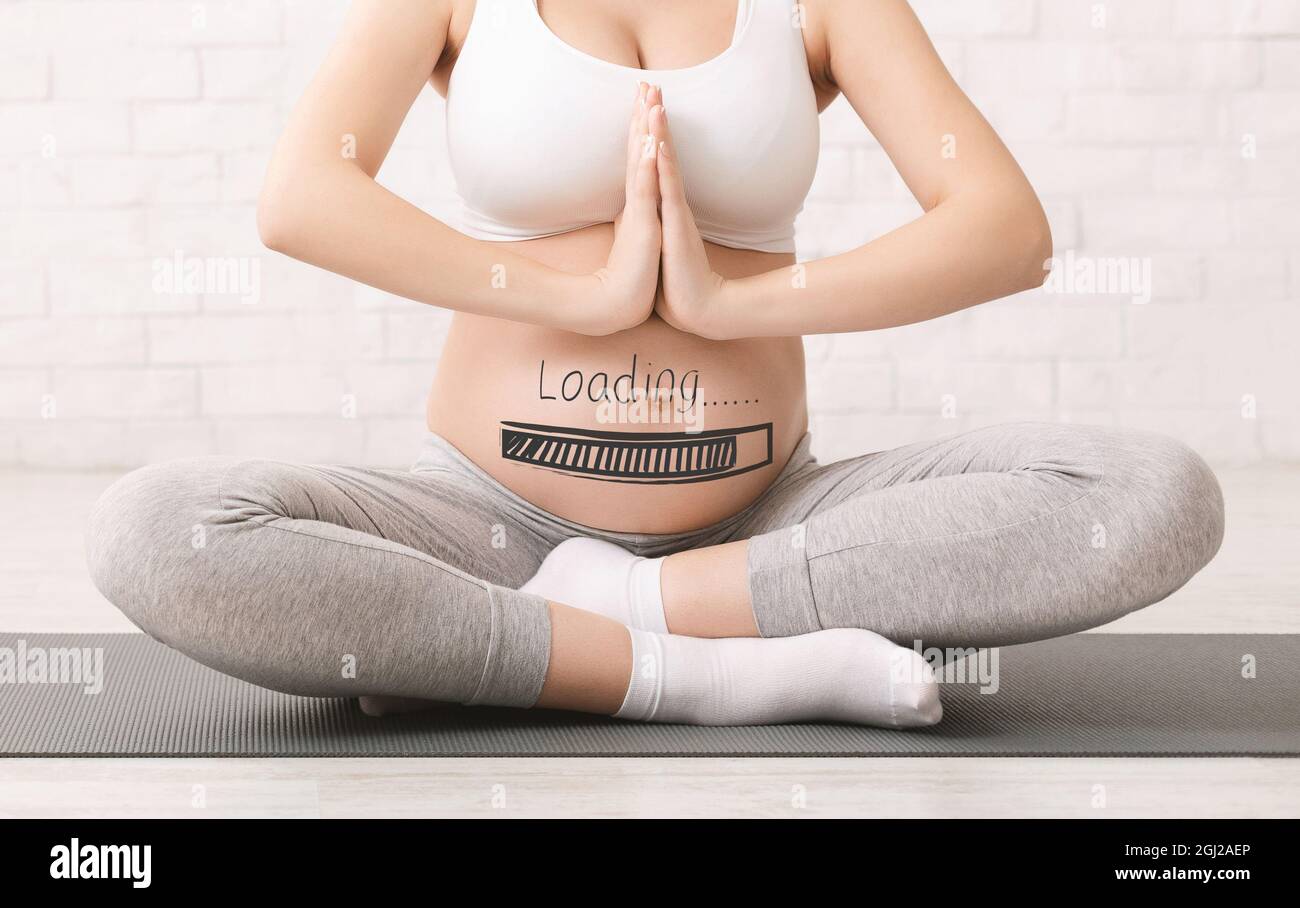 Closeup of expectant woman relaxing, practicing yoga or meditation, making namaste gesture indoors, collage with progress loading bar on pregnant bell Stock Photo