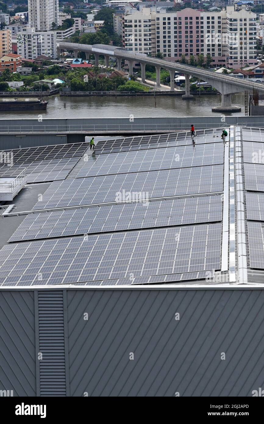 Engineering install Solar Cell system on a Roof top of the building to absorb sunlight as a source to generate electricity. Stock Photo