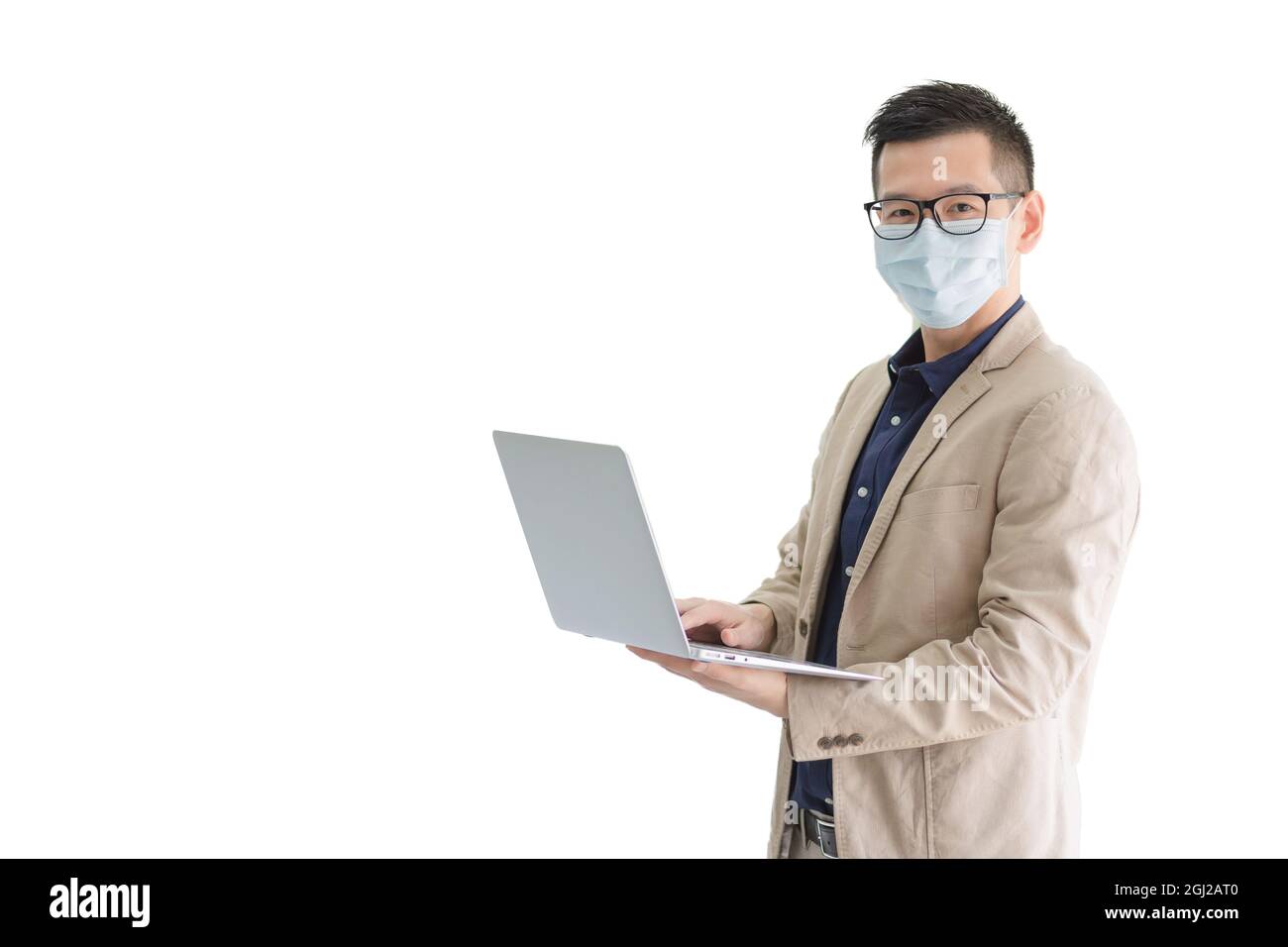 Business employees wearing hygienic mask holding smart computer isolate on white background with copy space. Stock Photo