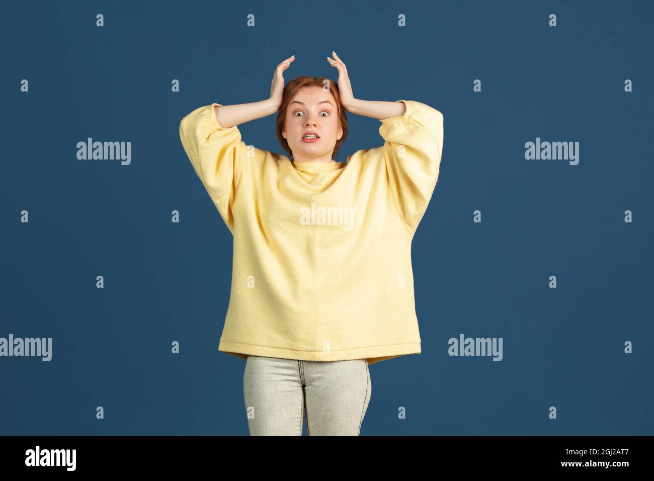 One caucasian young beautiful girl posing isolated over blue studio ...