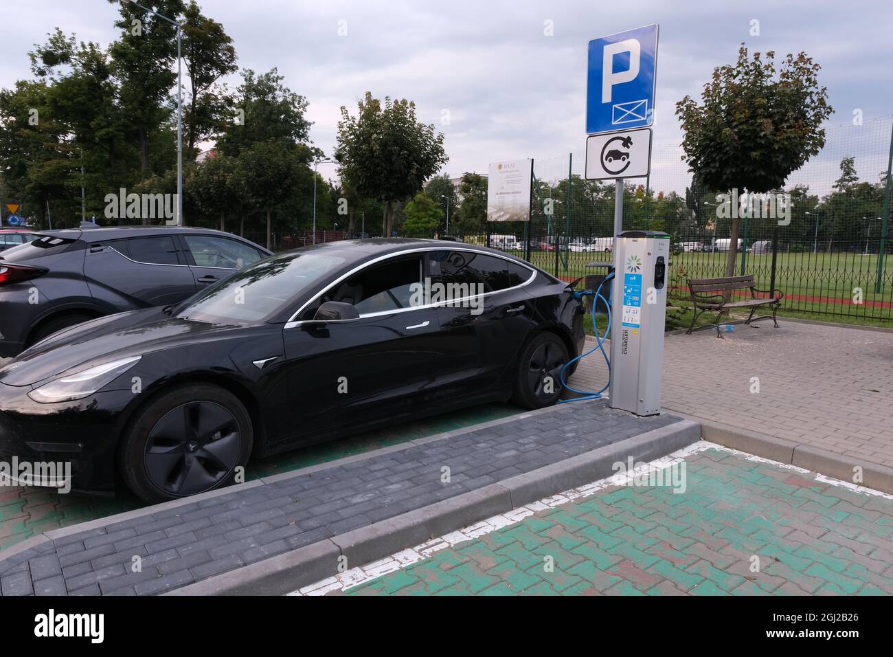 Skarbimierz Osiedle, Poland - August 21, 2021:  A static shot of a solid black Tesla Model 3 dual motor charging at the EVPlus AC charging station Stock Photo
