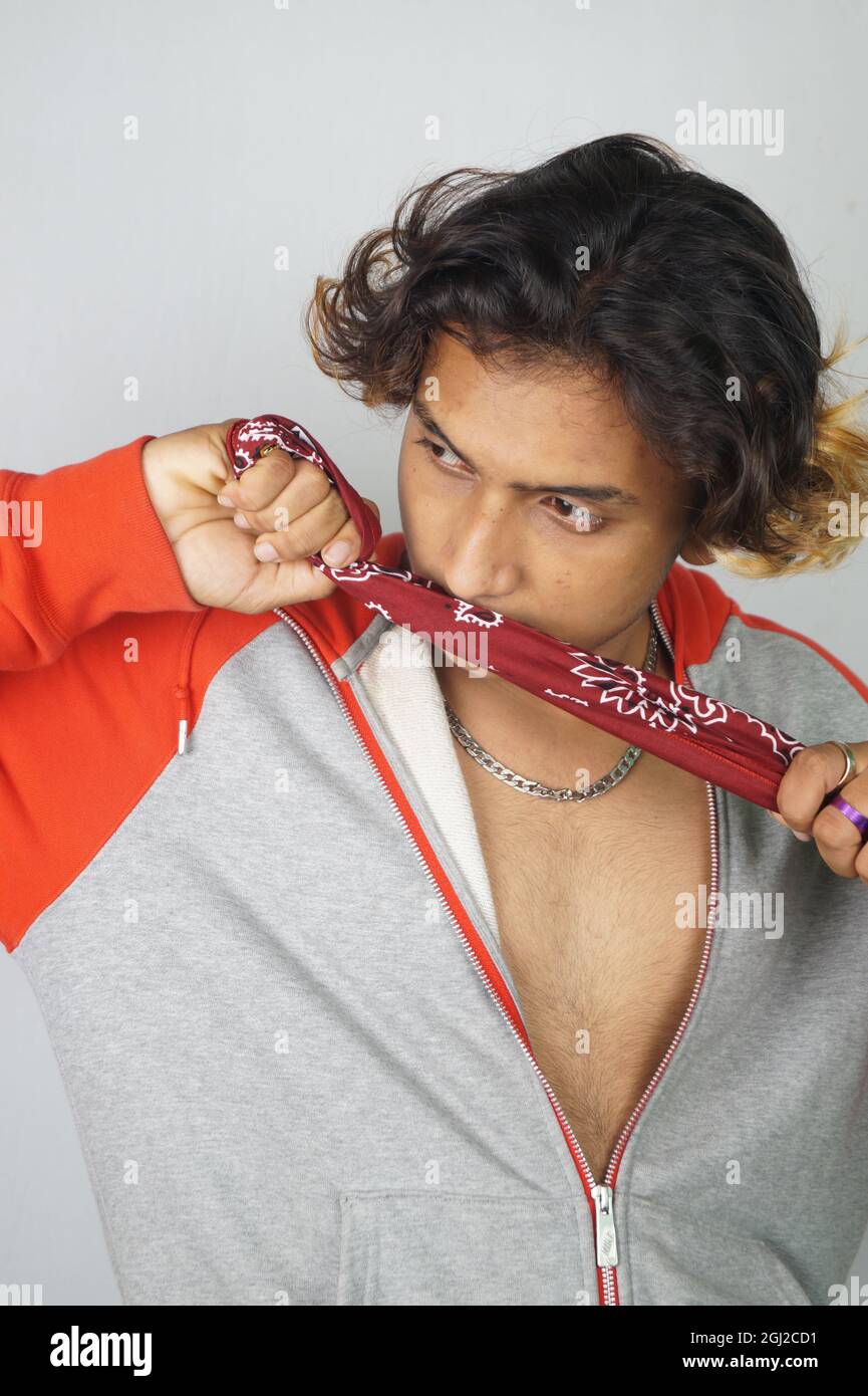 Vertical shot of an Indian hip male posing wearing a colorful scarf and  bandana Stock Photo - Alamy